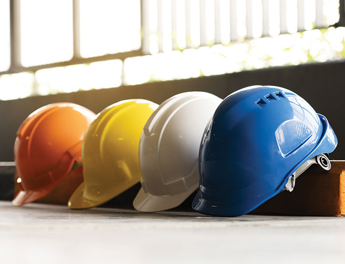 Safety Construction Worker Hats Blue, white, yellow, orange. Teamwork of construction team must have quality. Whether it engineer, construction workers. Have a helmet to wear at work. Safety at work.